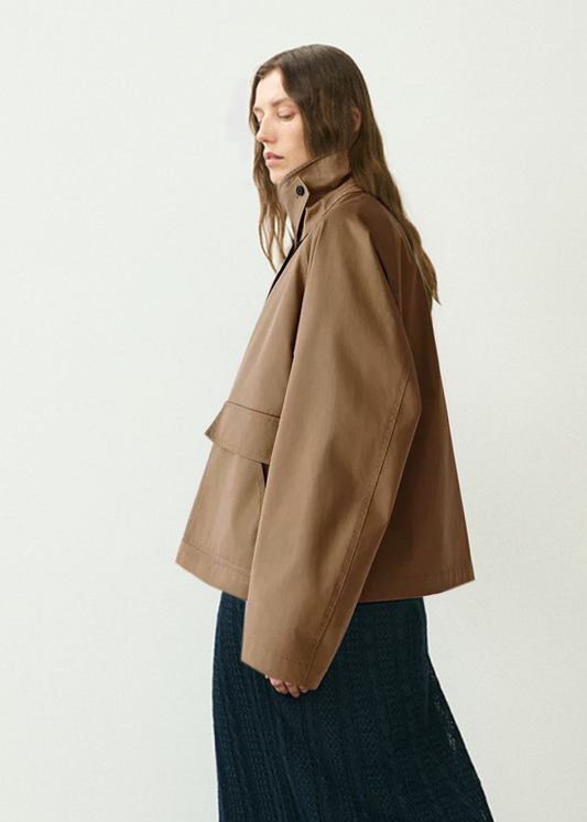Woman wearing a brown jacket on a white background